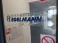 logo firmy wycięte w folii, naklejone na przeszkleniu przy wejściu